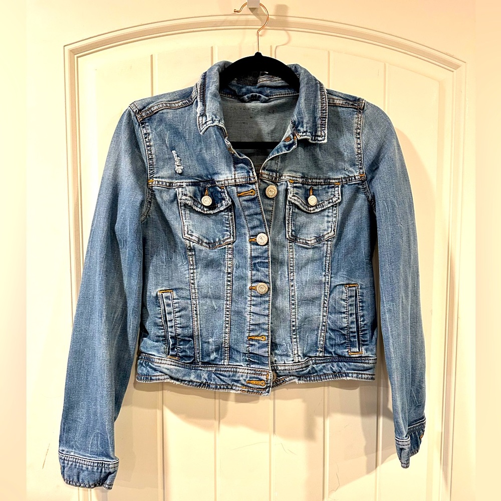 Denim jacket. With mild distressing.  Women’s medium.